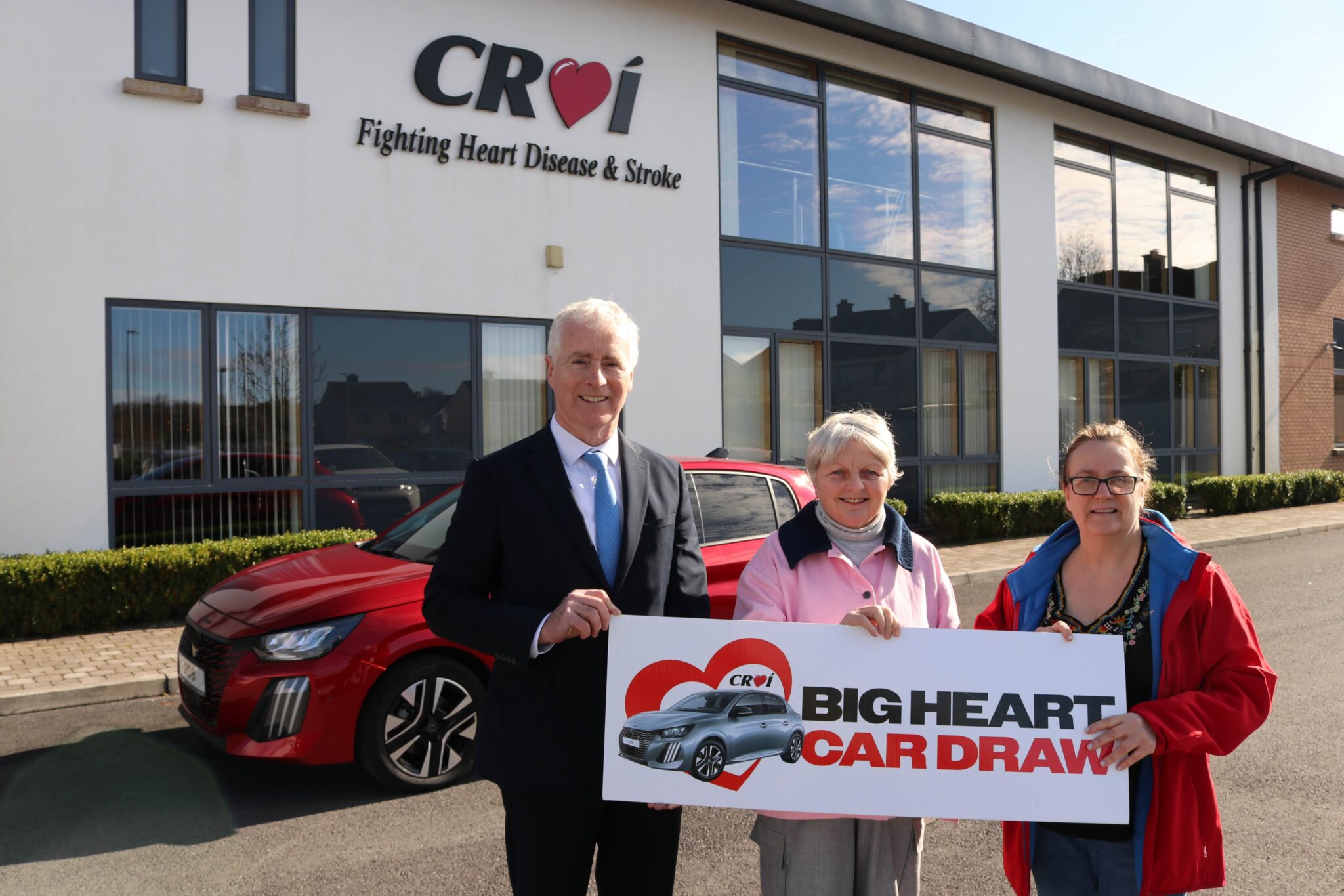 Dolores Kelly, winner of big heart car draw outside Croí House with Brian Kenny of Kenny Galway and Christine Flanagan, Croí Director of Fundraising.